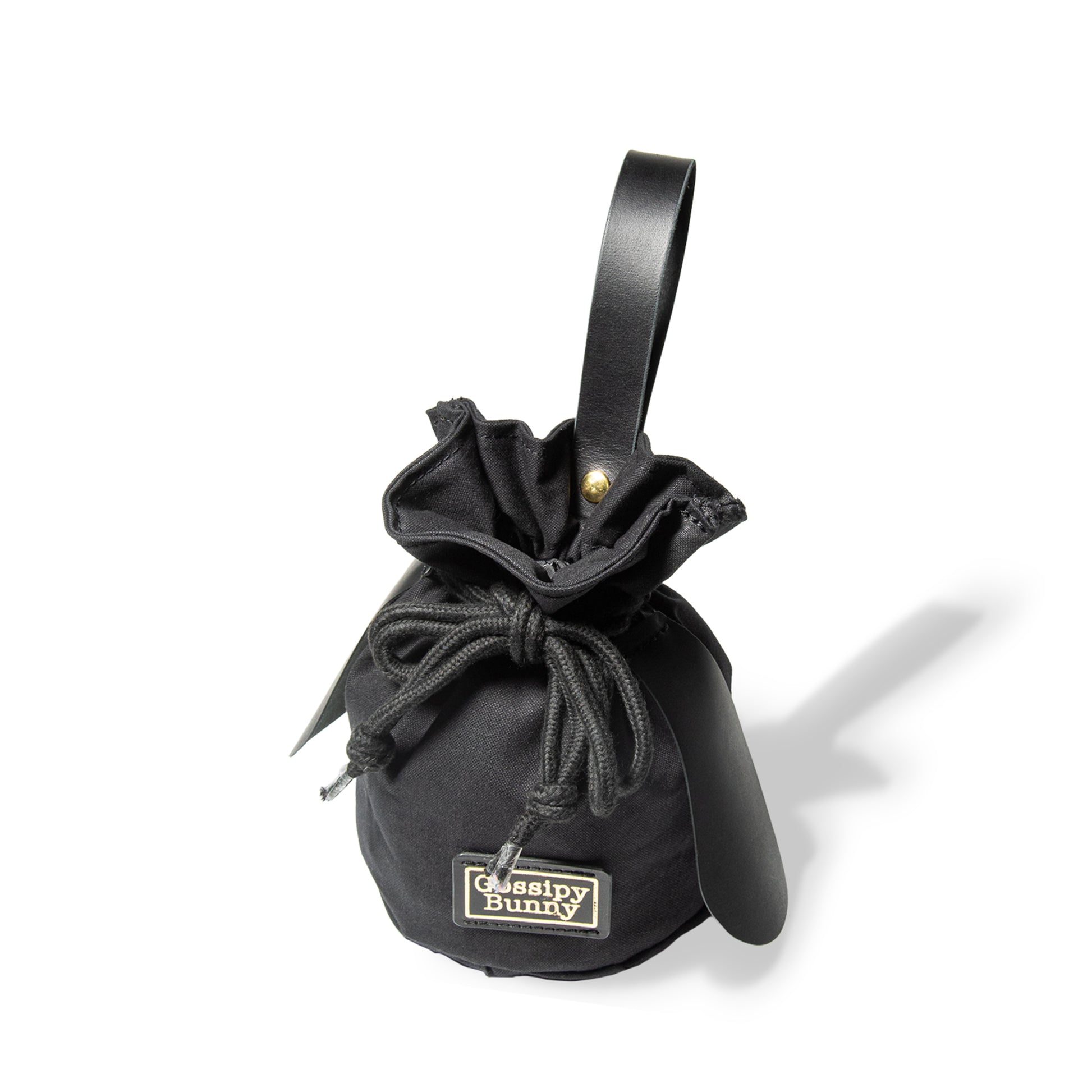 Roavan（ローバン） Gossipy Bunny（ゴシッピーバニー） Bunny Vup（バニーバップ） 巾着型ポーチ。倉敷帆布とブラックレザーの構成、丸底形状、SMロープ、本革ループハンドル、垂れ耳モチーフを特徴とする携行用小型ポーチ。