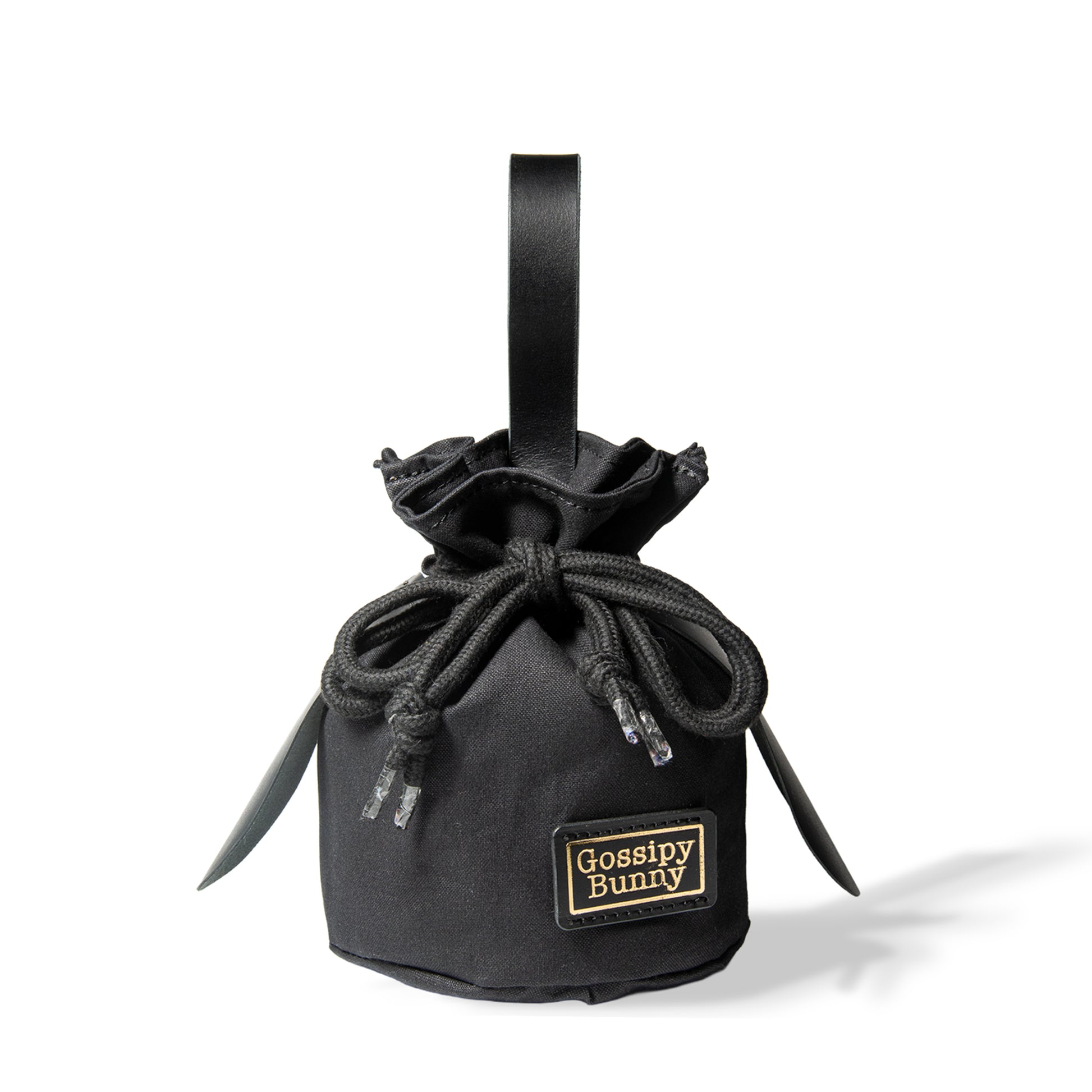 Roavan（ローバン） Gossipy Bunny（ゴシッピーバニー） Bunny Vup（バニーバップ） 巾着型ポーチ。倉敷帆布とブラックレザーの構成、丸底形状、SMロープ、本革ループハンドル、垂れ耳モチーフを特徴とする携行用小型ポーチ。