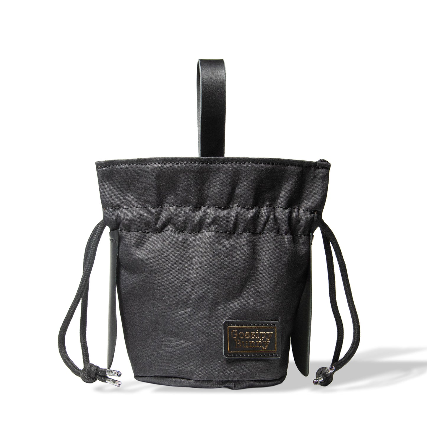 Roavan（ローバン） Gossipy Bunny（ゴシッピーバニー） Bunny Vup（バニーバップ） 巾着型ポーチ。倉敷帆布とブラックレザーの構成、丸底形状、SMロープ、本革ループハンドル、垂れ耳モチーフを特徴とする携行用小型ポーチ。