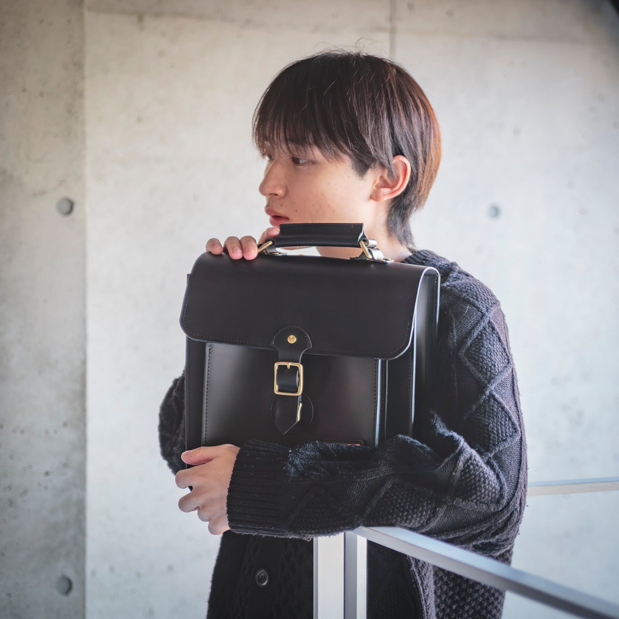 Roavan（ローバン）／RASWING（ラスウィング）／Gossipy Bunny（ゴシッピーバニー）のレザーバッグをモデルが実際に使用しているイメージ写真。日常の動きの中で、日本製ブランドの上質さと使う姿の美しさを表現したギャラリーカット。